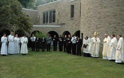 Archbishop Daniel M. Buechlein imparts a blessing on Sept. 8 at the end of the dedication of the new home of Bishop Simon Bruté College Seminary, 2500 Cold Spring Road, in Indianapolis. (Photo by Sean Gallagher) 