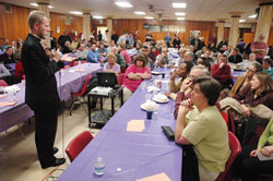 Father Tadeusz Pacholczyk, director of education at the Philadelphia-based National Catholic Bioethics Center, speaks on stem cell research and cloning to a standing-room only crowd of nearly 350 people on March 11 at Our Lady of the Most Holy Rosary Parish in Indianapolis. The presentation took place two days after President Barack Obama issued an executive order that allows federal funding of embryonic stem-cell research. (Photo by Sean Gallagher) 