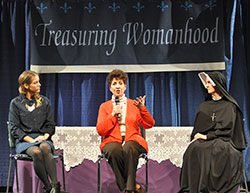 Janet Sahm, left, and Our Lady of Mercy Sister Caterina Esselen, right, listen as Julia Calandra-Lineberg answers a question from a woman attending the Indiana Catholic Women’s Conference on March 22. (Photo by Natalie Hoefer)