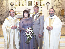 Bishop Charles C. Thompson, left, and his cousin, Father Dale Cieslik, right, pose after concelebrating the wedding Mass of their cousin Millie Cambron and her husband Joe Paul Brady on July 16, 2016, at St. Catherine Church in New Haven, Ky. (Photo courtesy Bob Knoll)