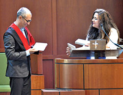 Oscar Castellanos, former archdiocesan director of the Office of Intercultural Ministry, admires an appreciation award given to him by the Edinburgh community 2019-2021 graduates of the archdiocesan Intercultural Pastoral Institute at St. Bartholomew Church on June 5. The award was presented by graduate Raquel Contreras. (Photo by Natalie Hoefer)