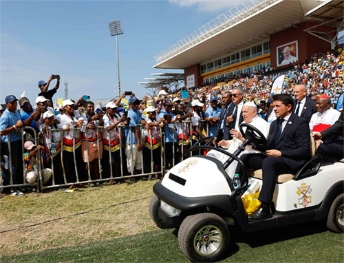 Pope Francis is greeted by young people as he arrives in a golf cart at Sir John Guise Stadium for a special meeting with youth in Port Moresby, Papua New Guinea, Sept. 9, 2024. (CNS photo/Lola Gomez)